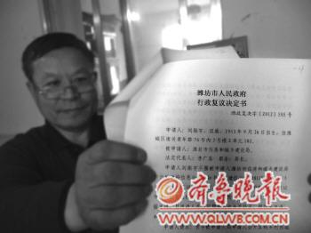 市民刘先生展示他拿到的市政府行政复议书